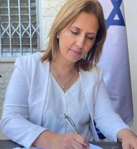 Israeli Environmental Protection Minister Gila Gamliel signs an amendment banning fur sales to the fashion industry. (Courtesy of Environmental Protection Ministry)